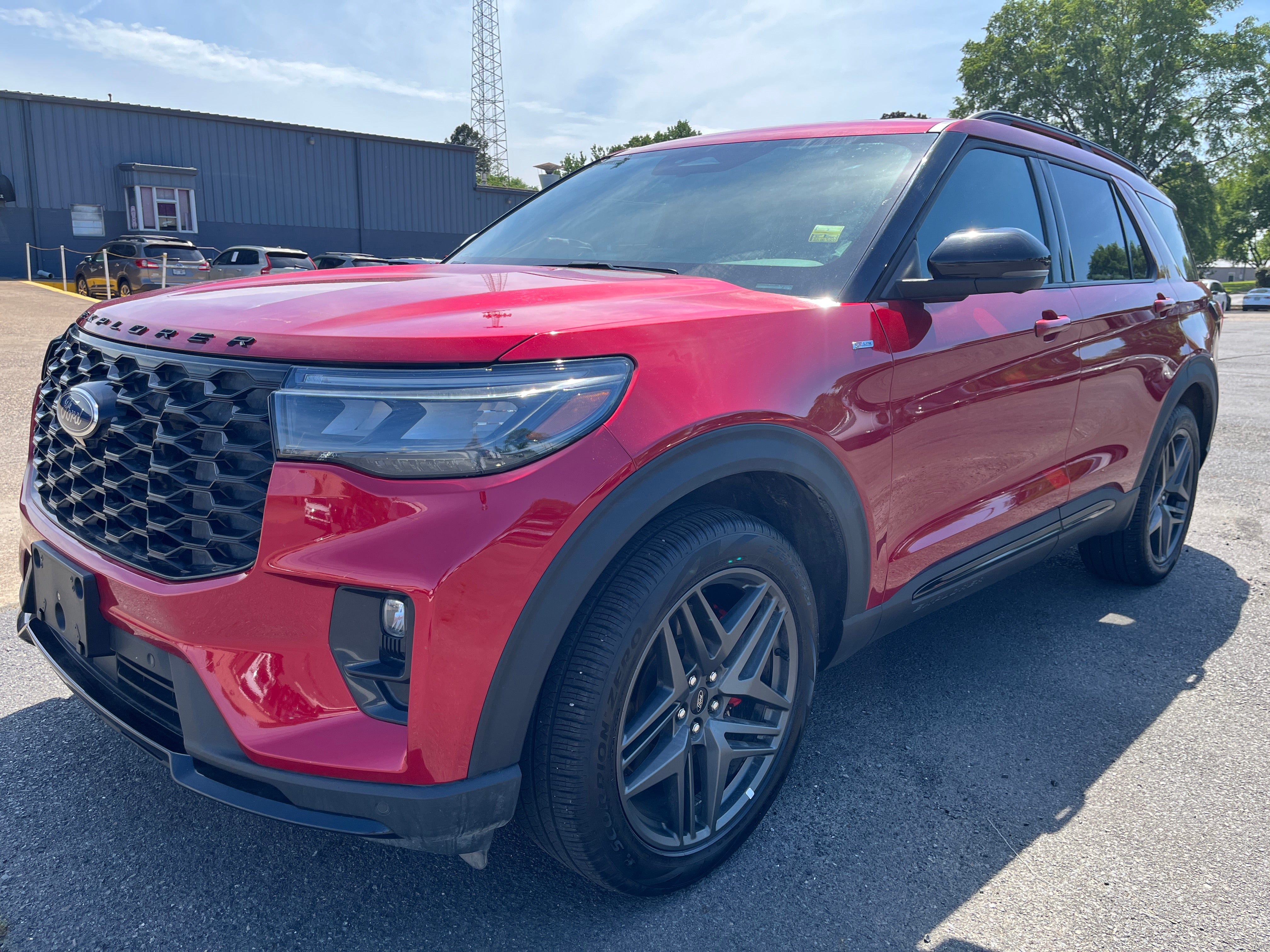 2025 Ford Explorer ST-Line in Rapid Red — front three-quarter view