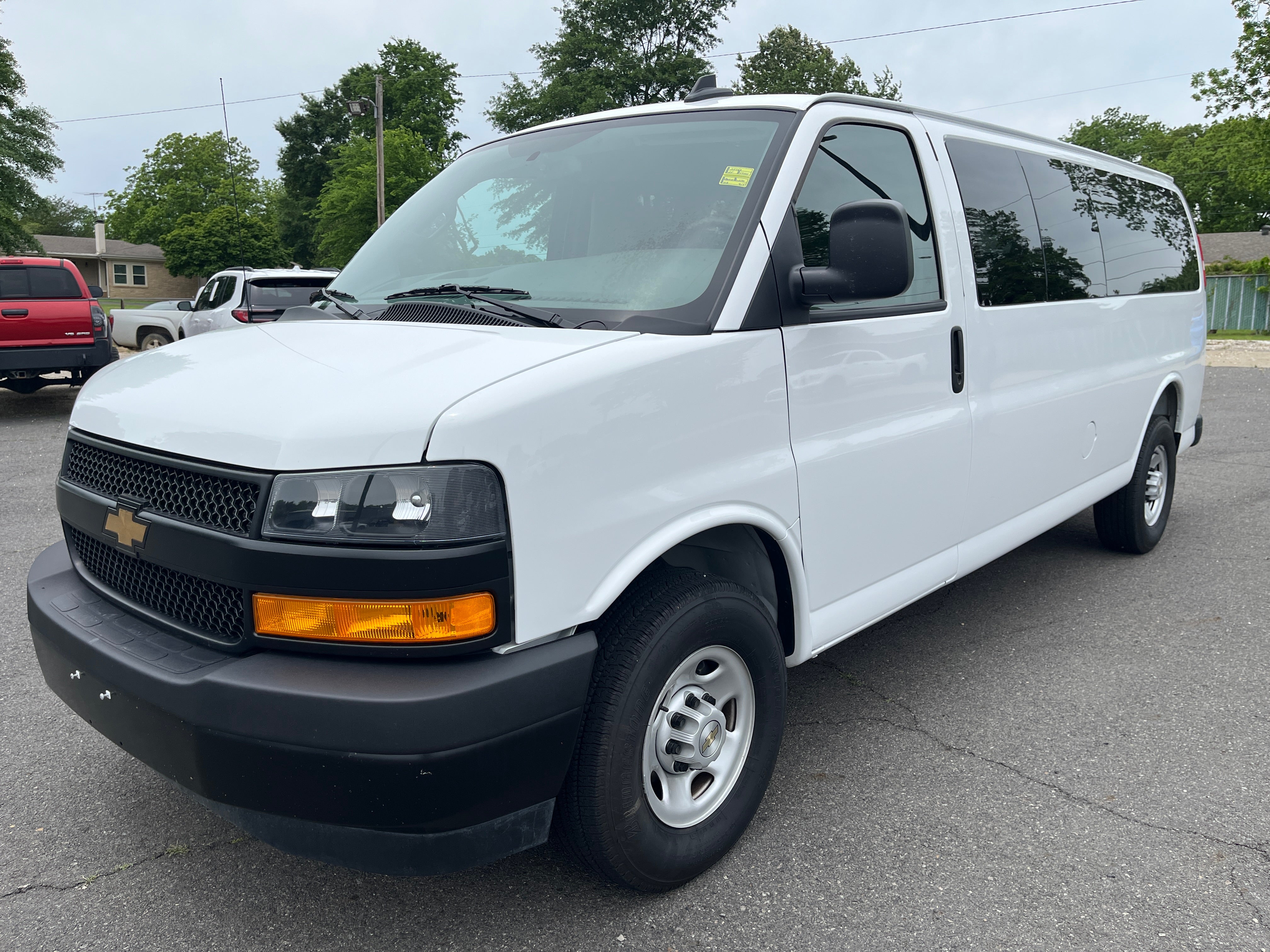 2025 Chevrolet Express Passenger 1LS in Summit White — front three-quarter view