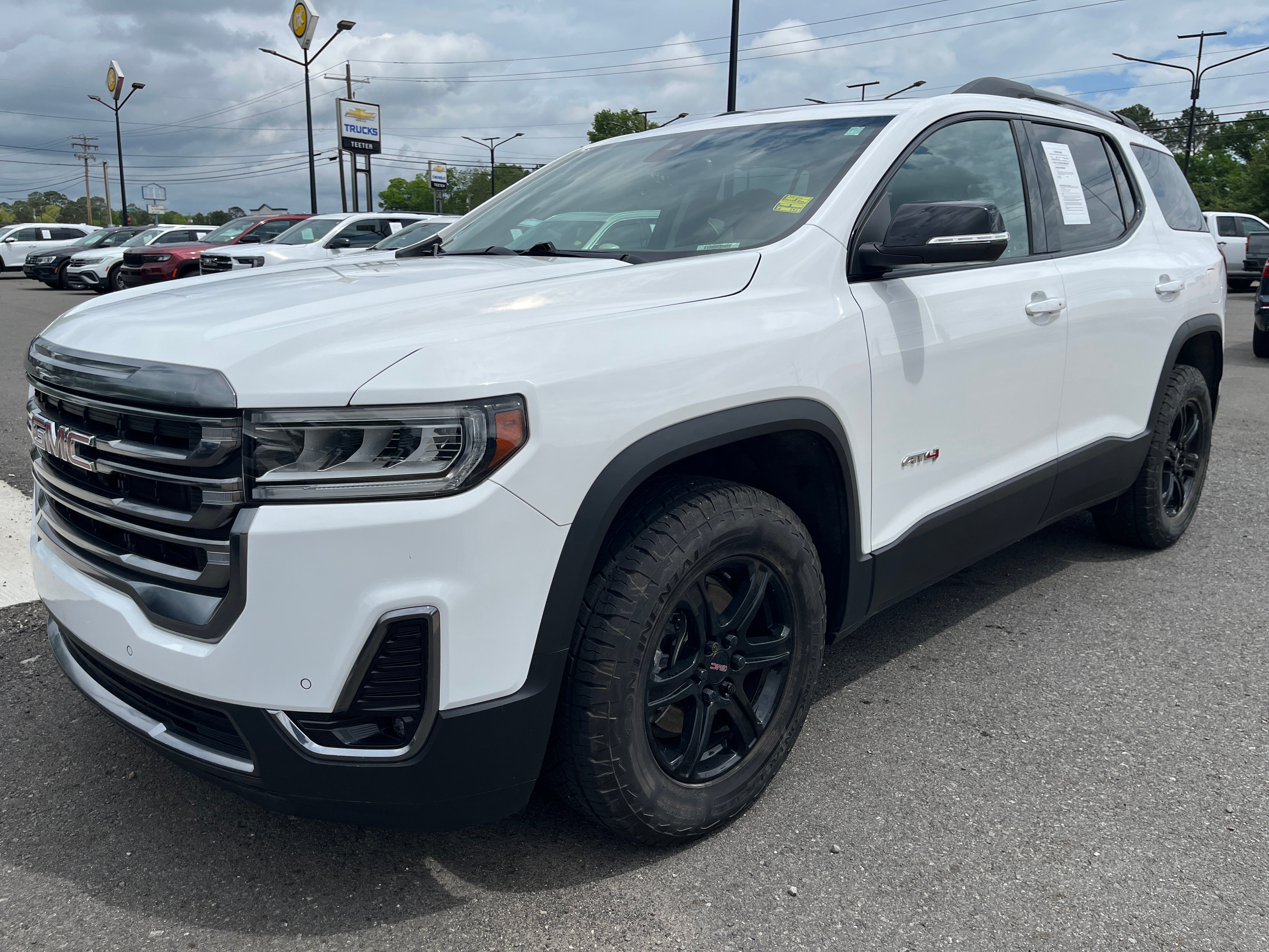 2023 GMC Acadia AT4 in Summit White — front three-quarter view