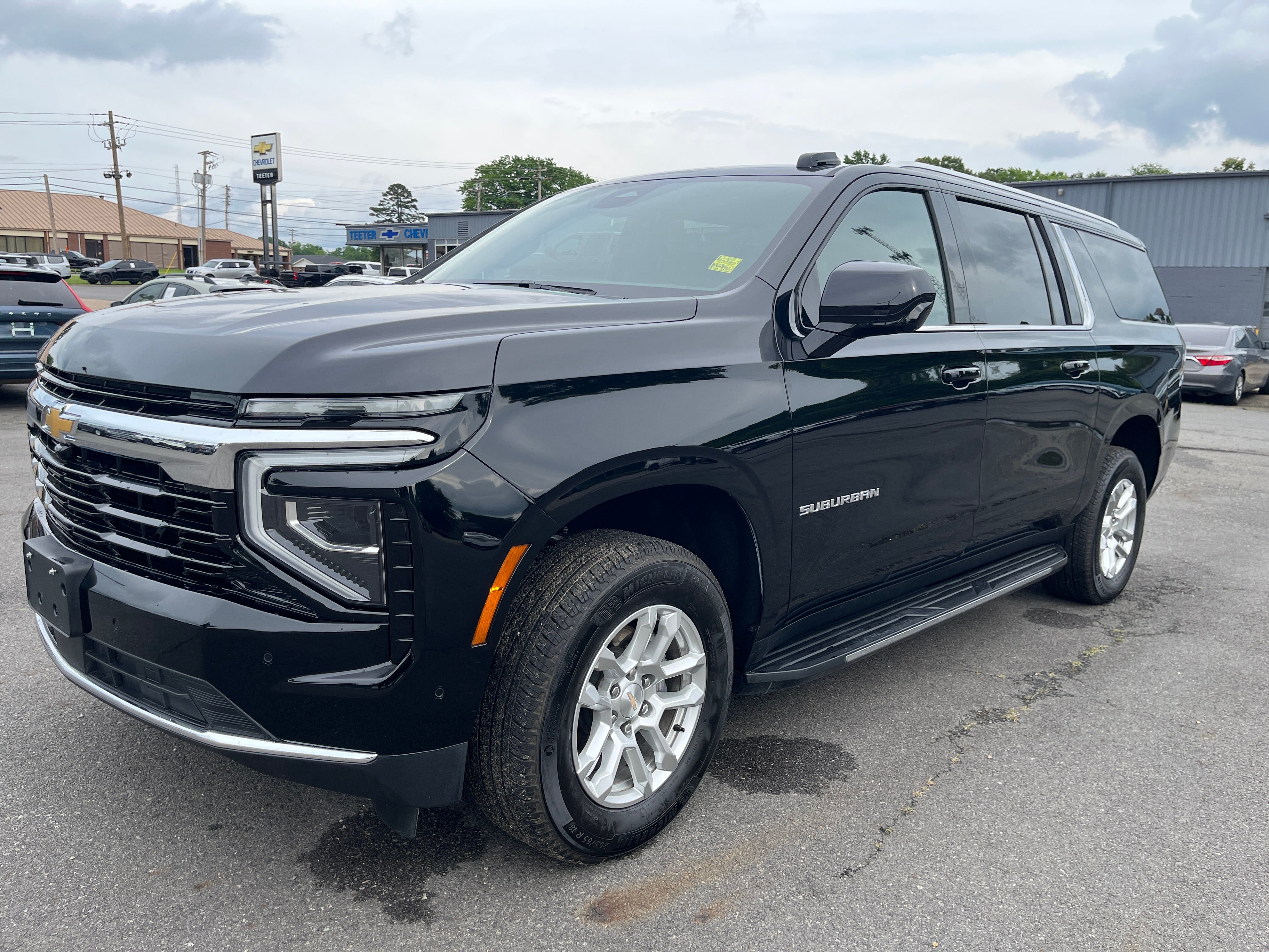 2025 Chevrolet Suburban LS in Black — front three-quarter view
