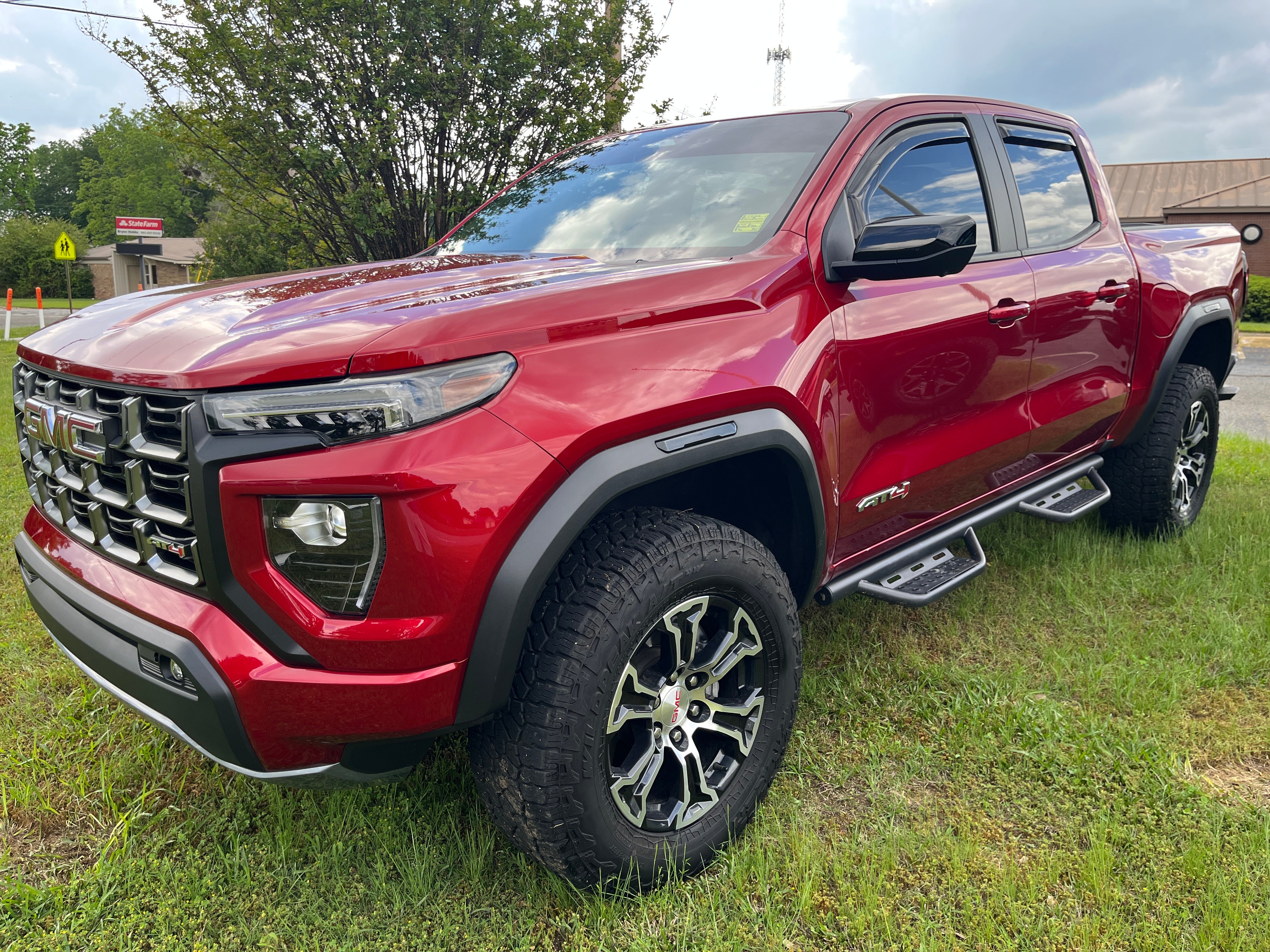 2024 GMC Canyon AT4 in Volcanic Red Tintcoat — front three-quarter view