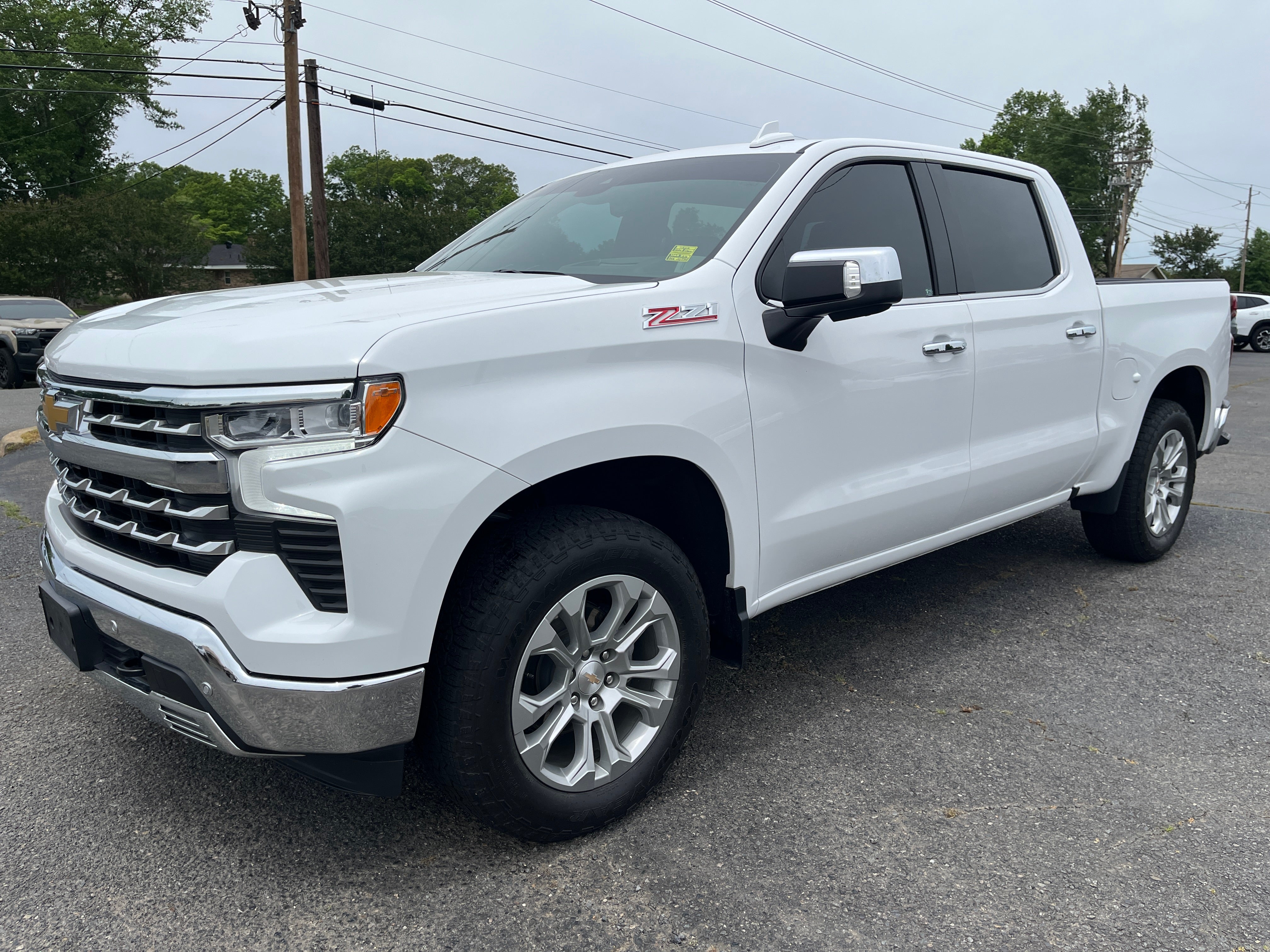 2024 Chevrolet Silverado 1500 LTZ in Summit White — front three-quarter view