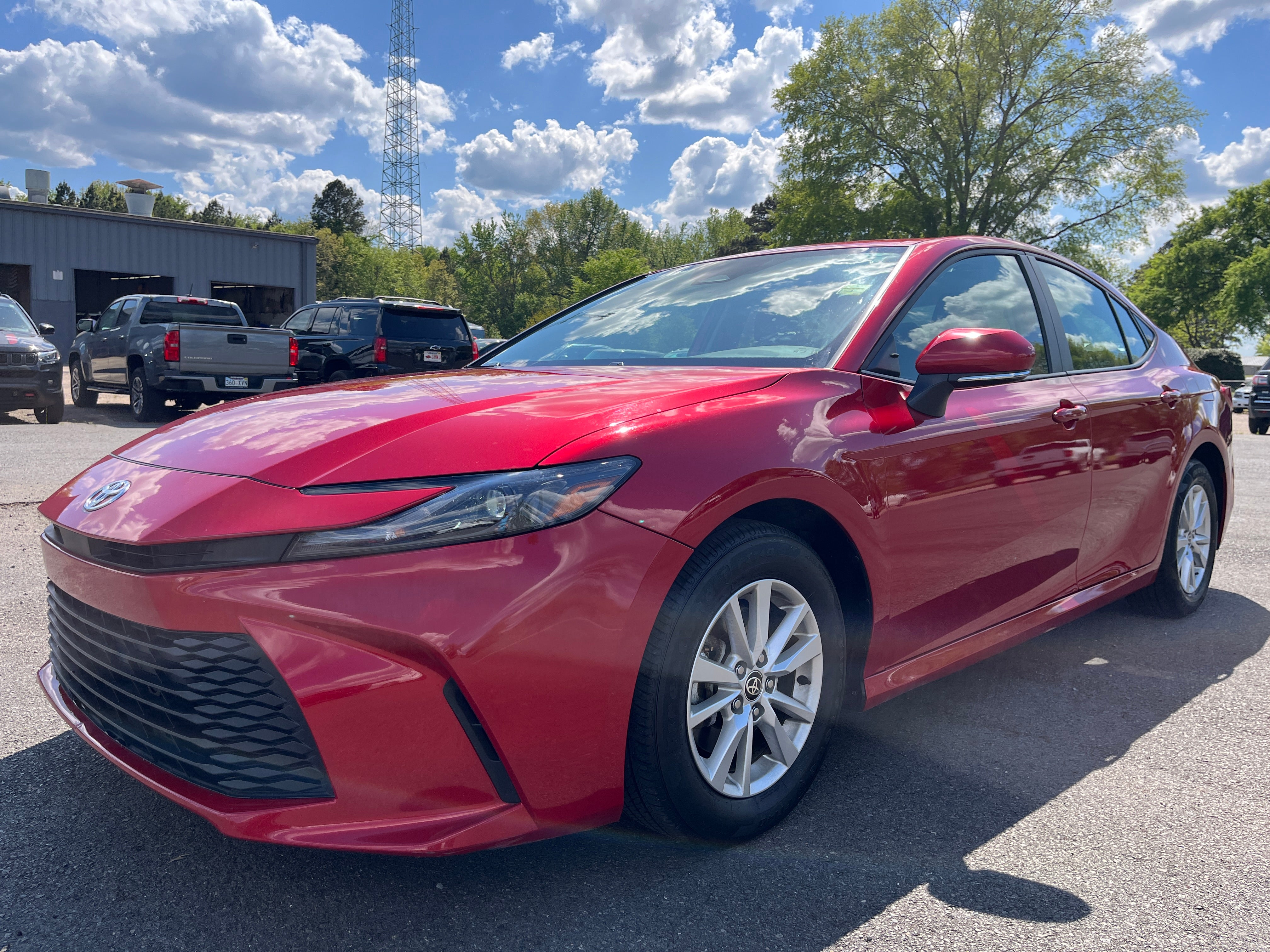 2025 Toyota Camry LE in Red — front three-quarter view