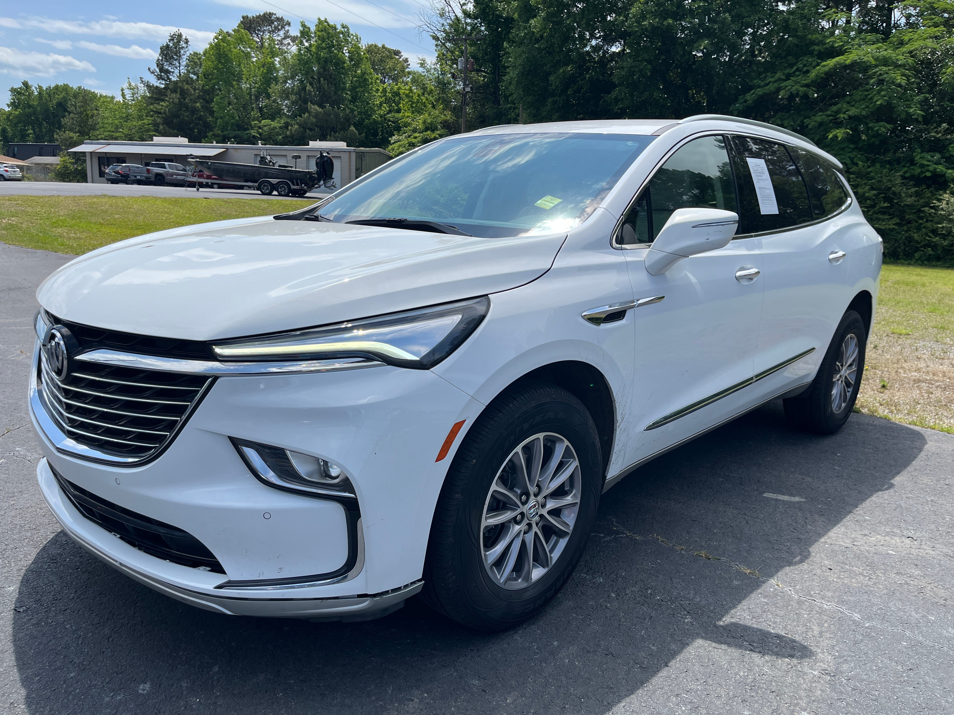 2024 Buick Enclave Essence in Summit White — front three-quarter view