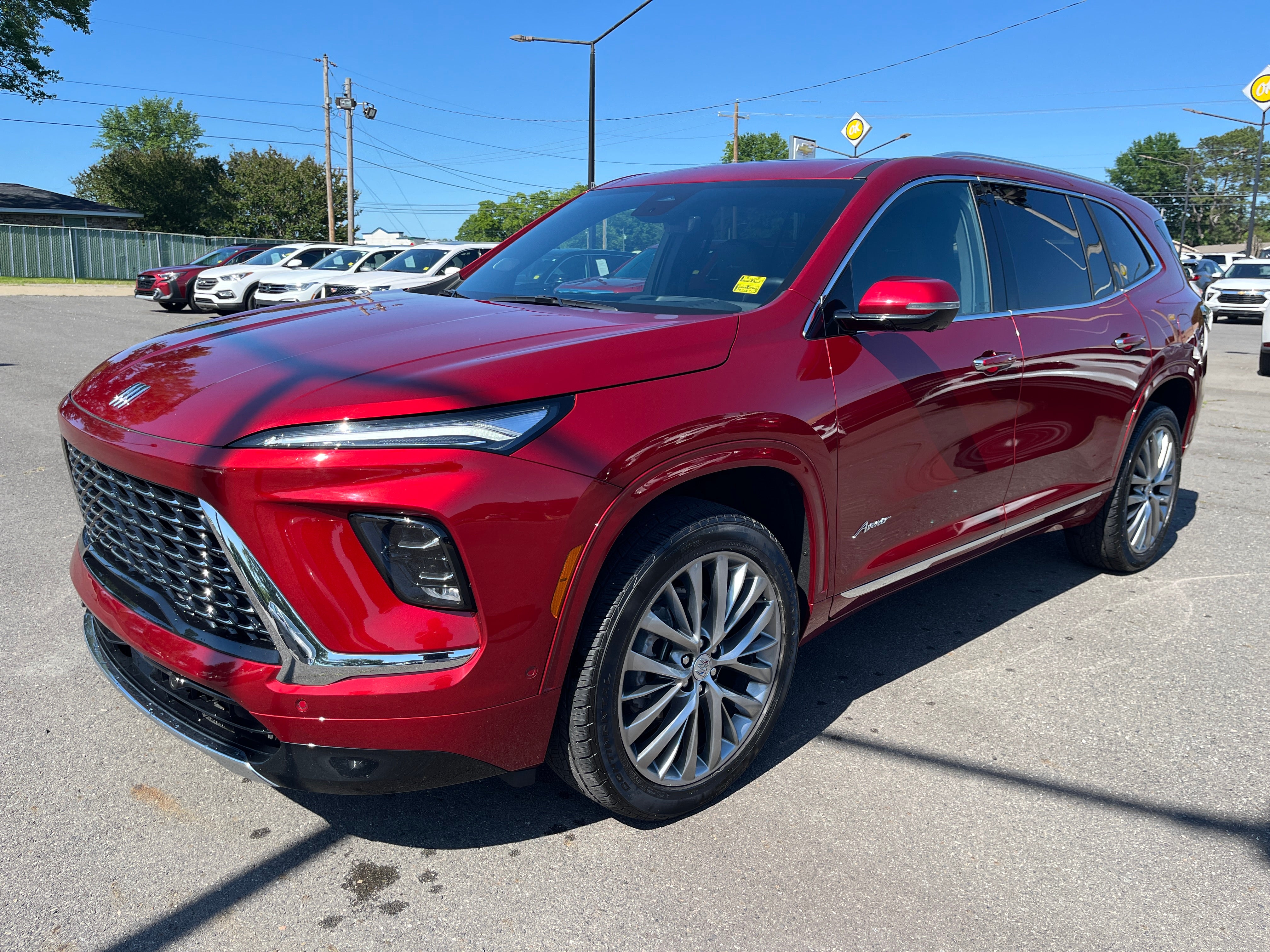 2025 Buick Enclave Avenir in Cherry Red Tintcoat — front three-quarter view