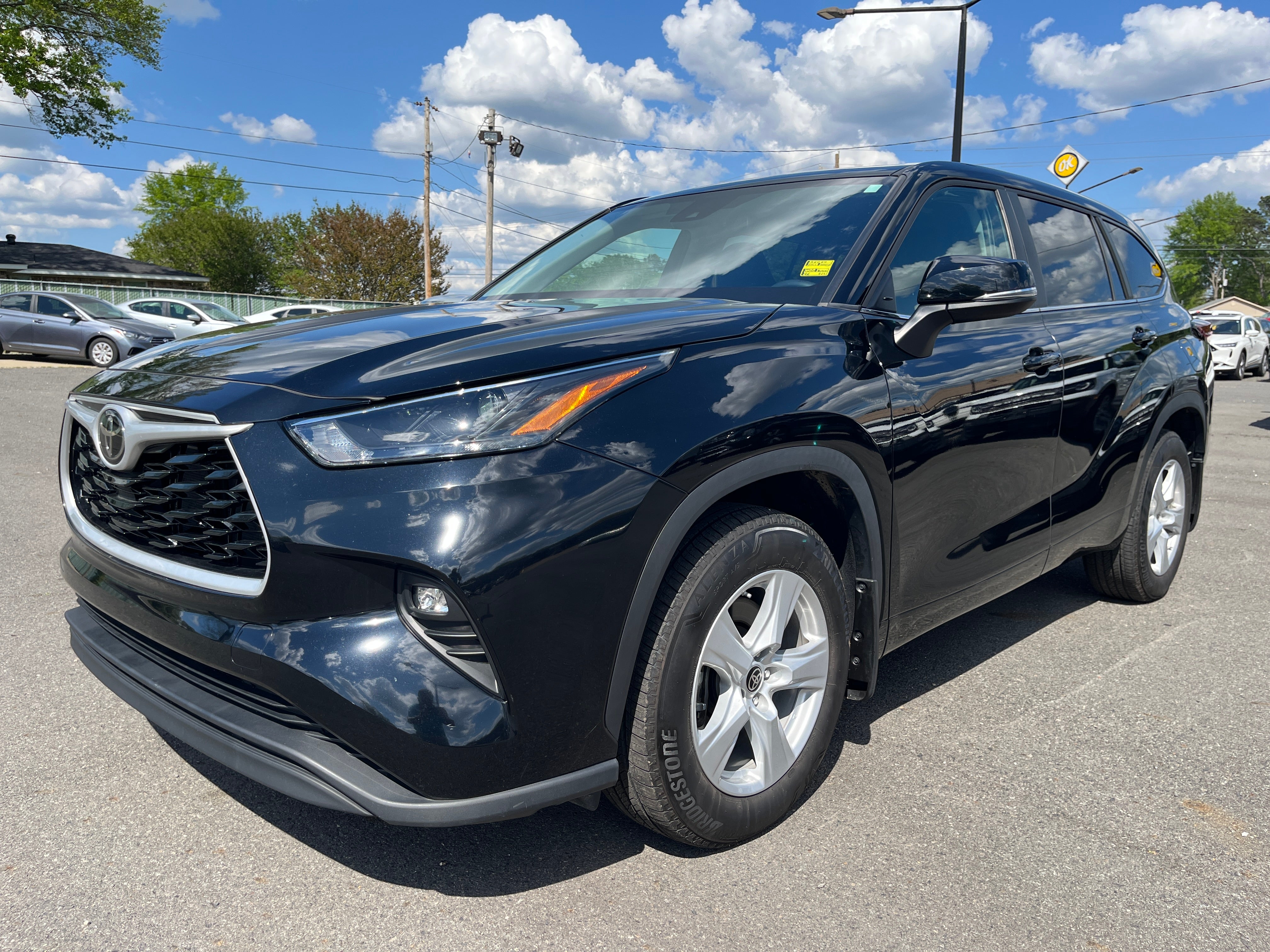 2024 Toyota Highlander LE in Black — front three-quarter view